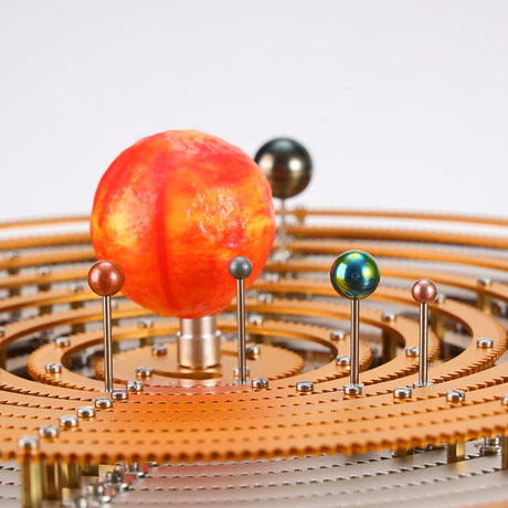 Mechanical solar system orrery model showing precision metal gears and planetary rings