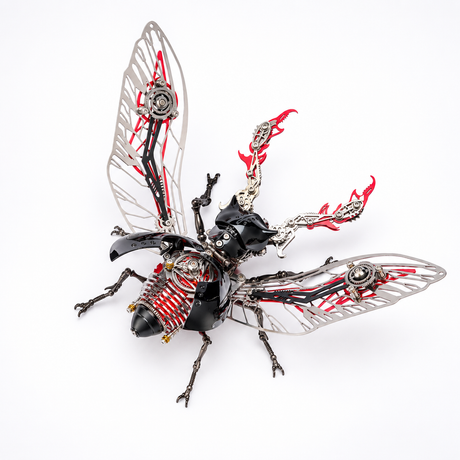 A highly detailed, steampunk-style insect sculpture or collectible model, resembling a cicada or beetle, featuring metallic silver wings with intricate gear mechanisms, a glossy black body, and red flame-like accents on its thorax and back, set against a plain white background.