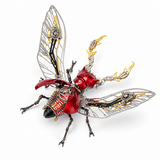 A highly detailed, steampunk-inspired mechanical beetle sculpture on a clean white background. The beetle features metallic silver wings with gold and black accents, a glossy red body, and intricate black and gold gears, rods, and mechanical parts.